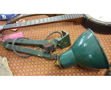 An early 20th century Industrial wall mounting angle poise iron wall light with green painted metal shade.