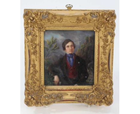 Mid 19th century Continental portrait miniature on porcelain, the seated young man depicted half length, before a mountainous