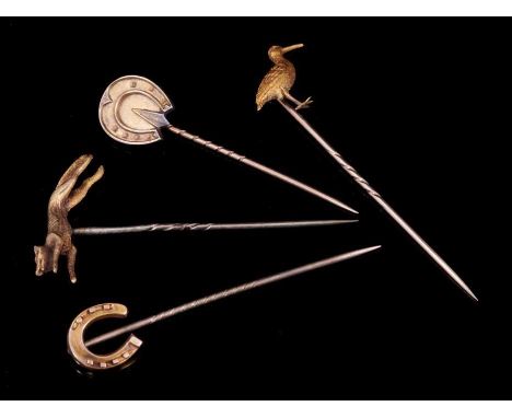 Four Victorian gold novelty stick pins to include one modelled as a running fox, another as a bird and two in the form of hor