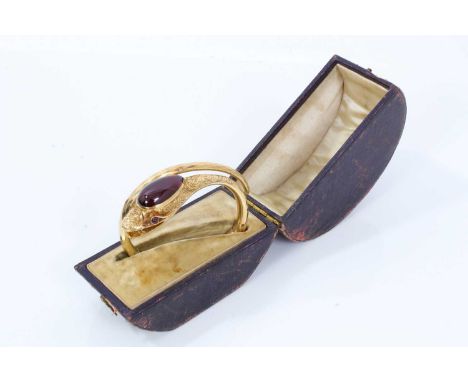 Victorian gold and cabochon garnet snake bangle, the snake's head with a large pear-shaped cabochon garnet and garnet eyes, o