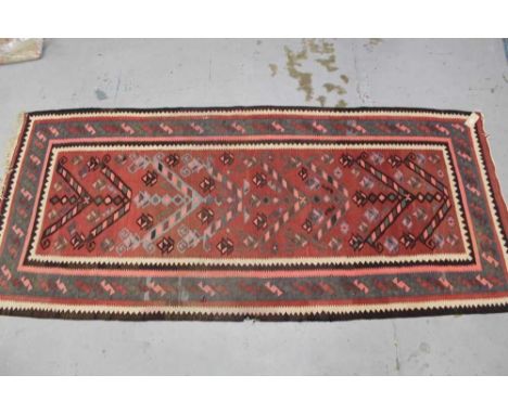 Kelim rug, with claret ground and arrow head repeat motif, geometric borders, 334 x 141cm