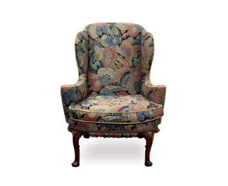 Early 18th century walnut wing armchair, tapestry upholstered high back and bowed seat raised on carved cabriole legsProvenan