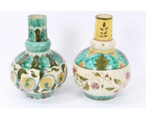 Near pair of Della Robbia vases, of bottle form with collared necks, painted with foliate patterns in a predominantly green a