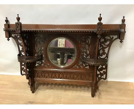 Early 20th century mahogany hanging shelves, central circular mirror below shaped shelf and flanking pierced brackets with se