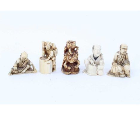 Group of five carved ivory netsuke, the largest carved in the form of a seated craftsman, 4cm high, another of two toads, thr