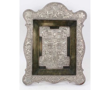 Antique white metal mounted icon, the central panel with Christ on the cross, within shaped vine embossed and velvet mounted 