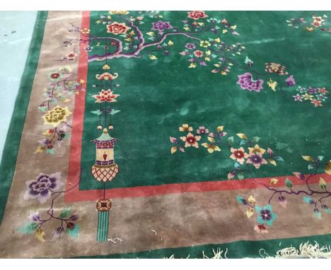 Chinese washed carpet on green ground with lantern and floral decoration, 418 x 329cm