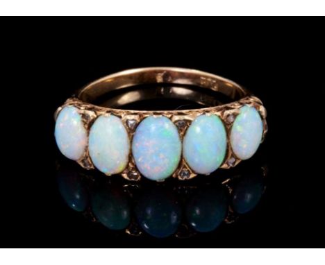 Late Victorian opal five stone ring with five graduated oval cabochon opals in carved gold setting with diamond accents, carv