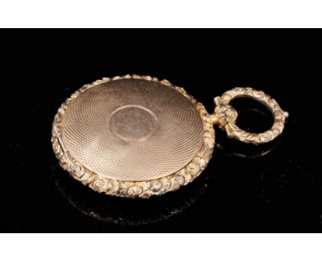 Regency yellow metal locket with circular engine turned decoration and cast foliage to the edge. 47mm x 32mmProvenance: Estat