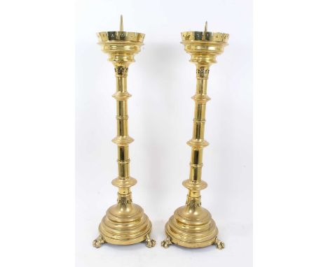 Pair of large 19th century gothic brass church pricket candlesticks, raised on paw feet, 72cm high together with a similar ta