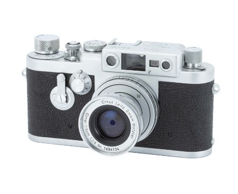 A Leica IIIg Delay Rangefinder Camera,1957, chrome, serial no. 871087, with Leitz Elmar f/2.8 50mm lens, 1957, chrome, serial