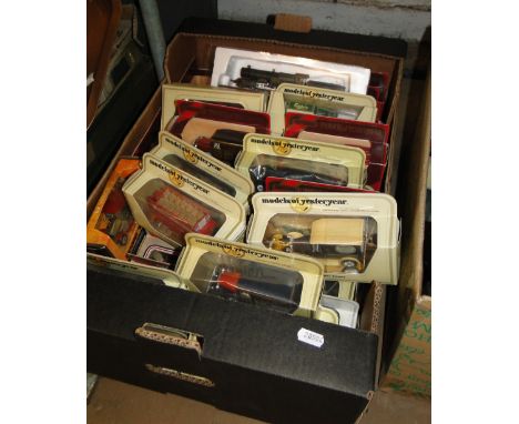 Quantity of boxed models of Yesteryear vans and buses and engine.