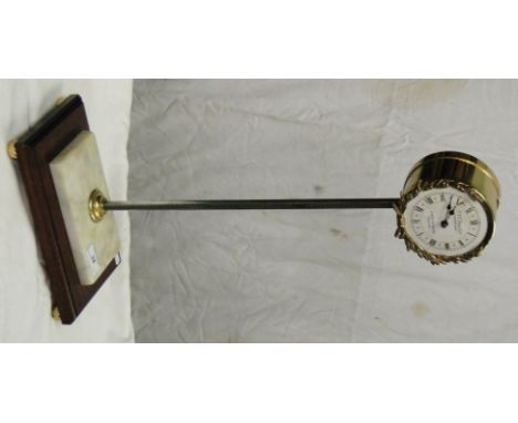 A brass framed gravity table top clock marked T W Bazeley, Cheltenham.