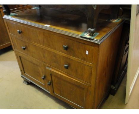 A 1930s walnut cabinet with 2 drawers and cupboards under, on bracket feet.