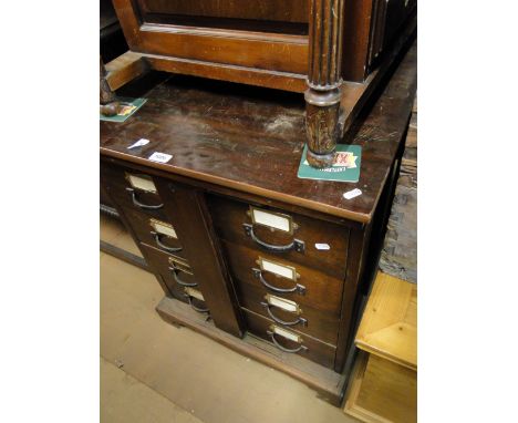 A Vintage stained wood 8 short drawer filing/index chest, with unusual sliding panel lock.