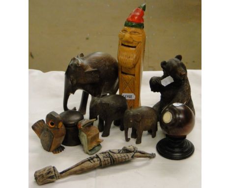 Black Forest carved wood bear, elephants and a novelty figure nutcracker, etc.