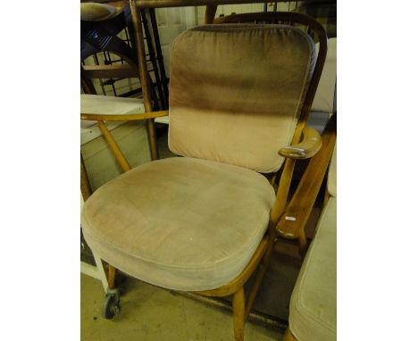 An Ercol "Windsor" light elm fireside armchair