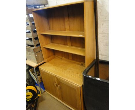 An Ercol light elm bookcase, with open shelves, cupboards under.