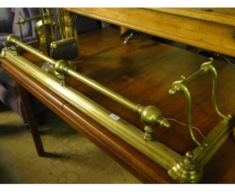 A Victorian brass fender and a companion set