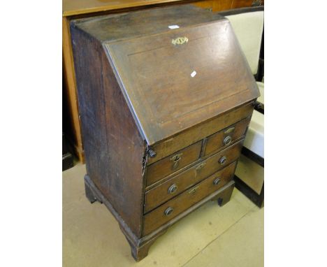 An early 18th century oak bureau, with a fitted interior and well, 2 short and 3 long drawers under, bracket feet, width 2'.