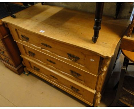 A continental pine commode, with 3 long panelled fronted drawers, carved pilasters, width 3'7".