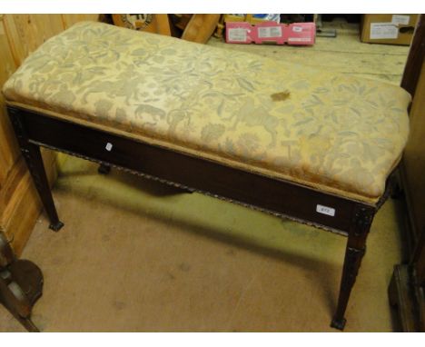 A Chippendale design mahogany duet stool with upholstered rising seat, tapered legs and applied carved decoration.