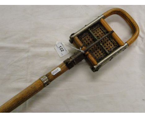 A cane seated shooting stick.
