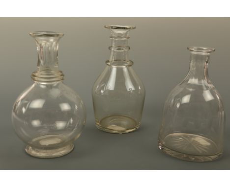 A Georgian Prussian bodied decanter and two later examples