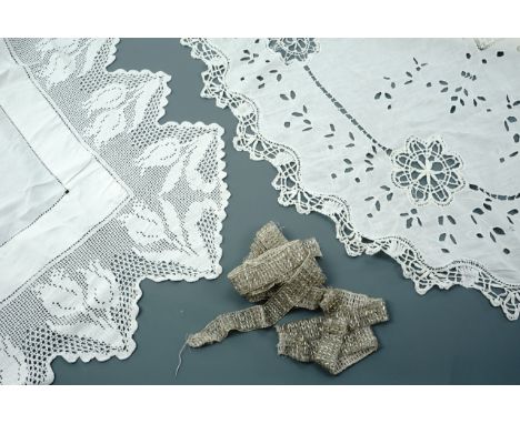 Antique textiles including a springtime white cotton tea table cloth with crocheted lace trim depicting tulips, one further c