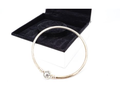 A Pandora white metal charm bangle, with bauble clasp, stamped '925', tested as silver, in original box, inner diameter appro