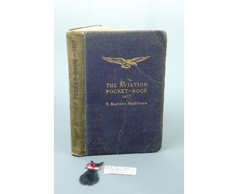 The Aviation Pocket-Book for 1917, its edges inscribed "Chas Odgers, 1917, England", together with a lucky black cat charm. ,
