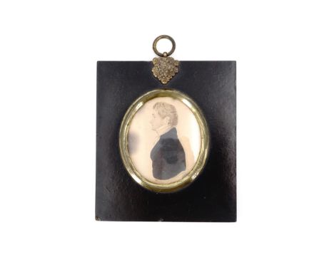 A late Georgian portrait miniature profile of a young gentleman in stock and black coat, watercolour on paper, in gilt metal 