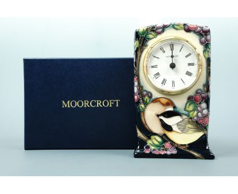 A contemporary Moorcroft limited edition mantle clock, the decoration depicting a pair of birds framed by boughs of berries, 