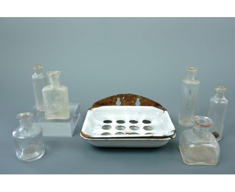 Victorian glass ink and medicine bottles together with a wall-hanging enamel soap dish