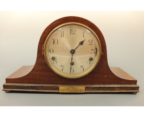 A 1930s mahogany cased "Napoleon hat" mantle clock with silvered face and Arabic numerals, with 1936 Post Office presentation