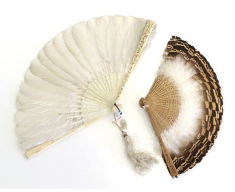 A Chinese Carved Ivory Feather Fan, Qing Dynasty, the heavily carved guards deeply and intricately carved with a head at the 