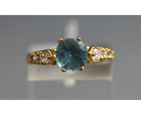 A 9 carat gold blue topaz and synthetic stone set dress ring, finger size L1/2, 2.5 g gross