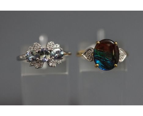 A 9 carat gold opal triplet and diamond ring, finger size P; with a 9 carat white gold  three stone tanzanite and diamond clu