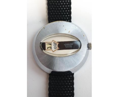 Loraine, a vintage jump hour digital watch with manual wind, on a nylon strap