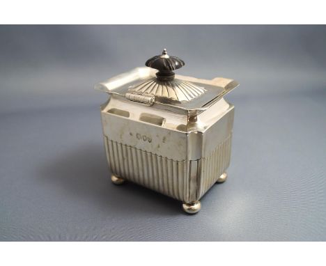 A late Victorian silver tea caddy, makers mark rubbed, London 1895, of rectangular outline, with cape rim and on bun feet, 8c