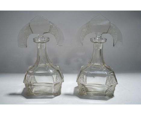 A pair of Art Deco style glass scent bottles, and stoppers with frosted vine moulded detail, 25cm high