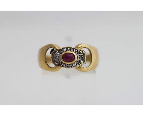 A 9 carat gold ruby and diamond ring, the cabochon enclosed by illusion set single cut stones, finger size O, 3.4 g gross