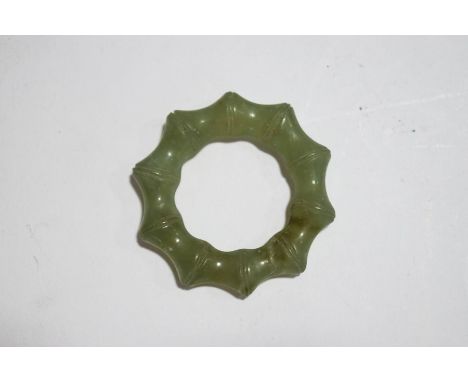 A Chinese carved jade ring, 5cm diameter