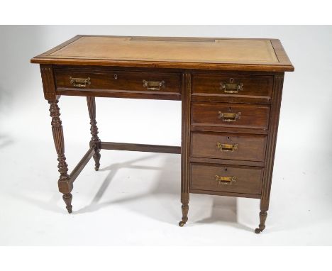 An Edwardian mahogany desk with leather inset top above an arrangement of five drawers on turned legs with ceramic casters, 7
