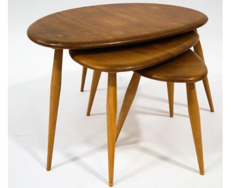 An Ercol nest of three 'Pebble' tables, the largest 40cm high, 65cm wide