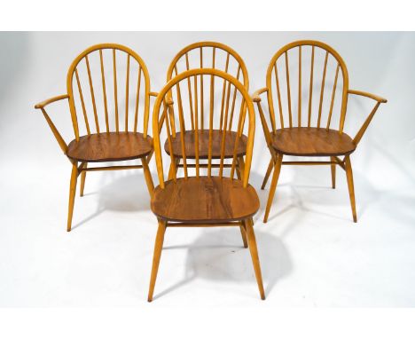 A set of four Ercol beech and elm stick back chairs, including two elbow, with High Wycombe label