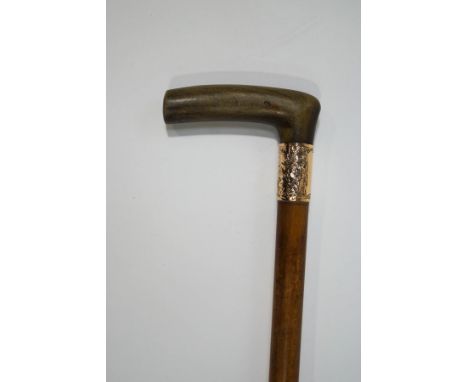 A Malacca shafted walking stick with horn handle and 1 1/4" wide collar