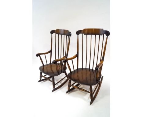 A pair of Ercol style beech rocking chairs with stick backs