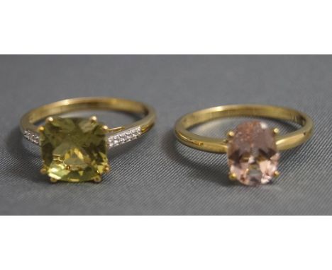 A 9 carat gold gem set dress ring, with stone set shoulders, finger size P; and a 9 carat gold single stone set dress ring, f