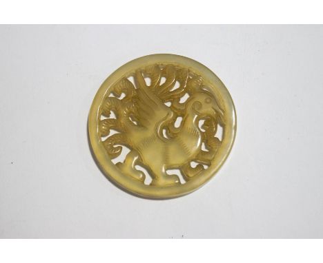 A 19th century Chinese jade carved plaque of a phoenix, 5cm diameter